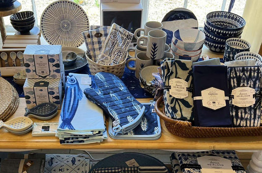An assortment of blue and white dishes and cloth napkins from Leaf & Anna.